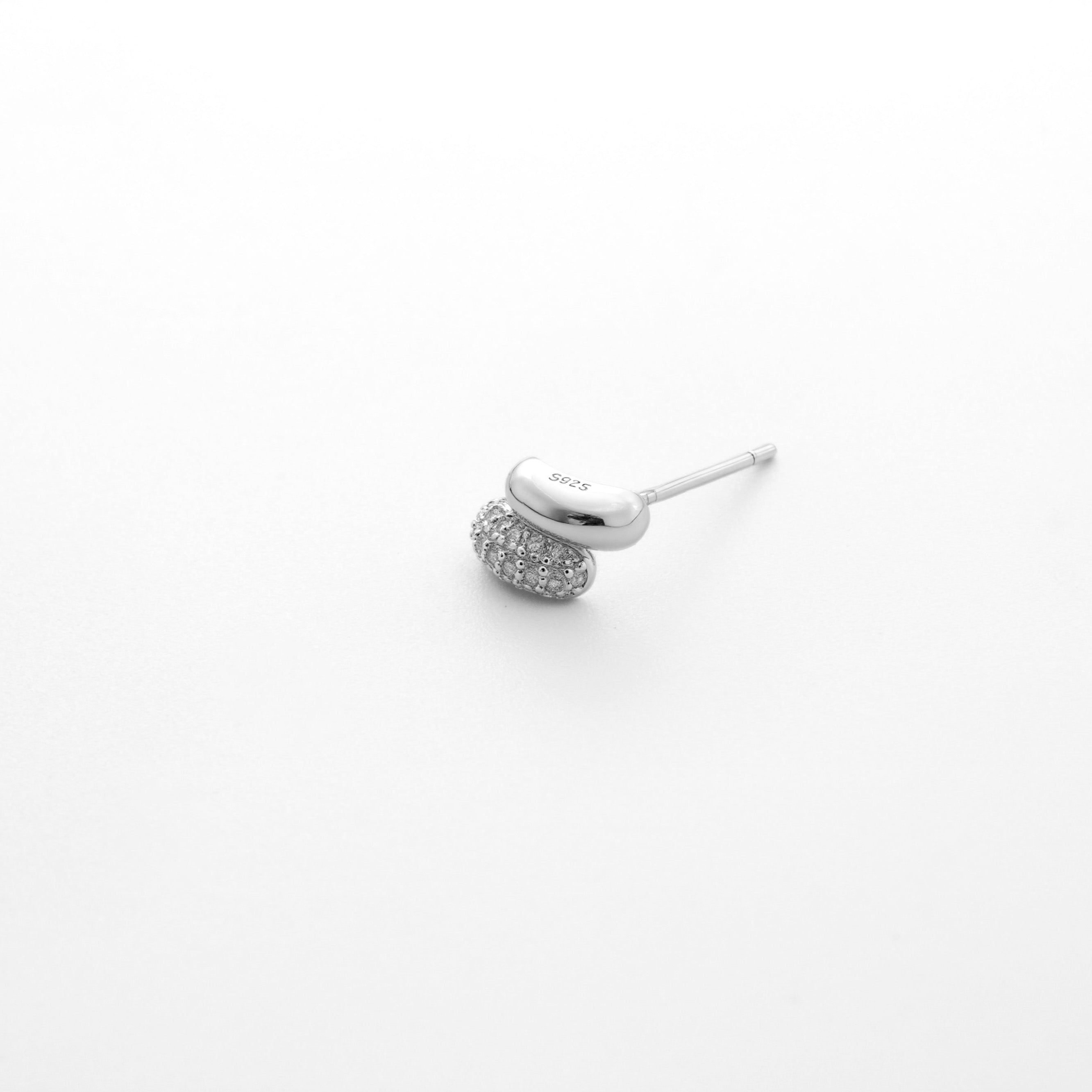 Fine jewellery, silver jewellery, hypoallergenic, tarnish-free, close-up overlooking view of a f silver ear studs embedded with crystals in a light grey background