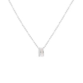 A delicate silver chain necklace with a small double-ring pendant, displayed against a solid white background.