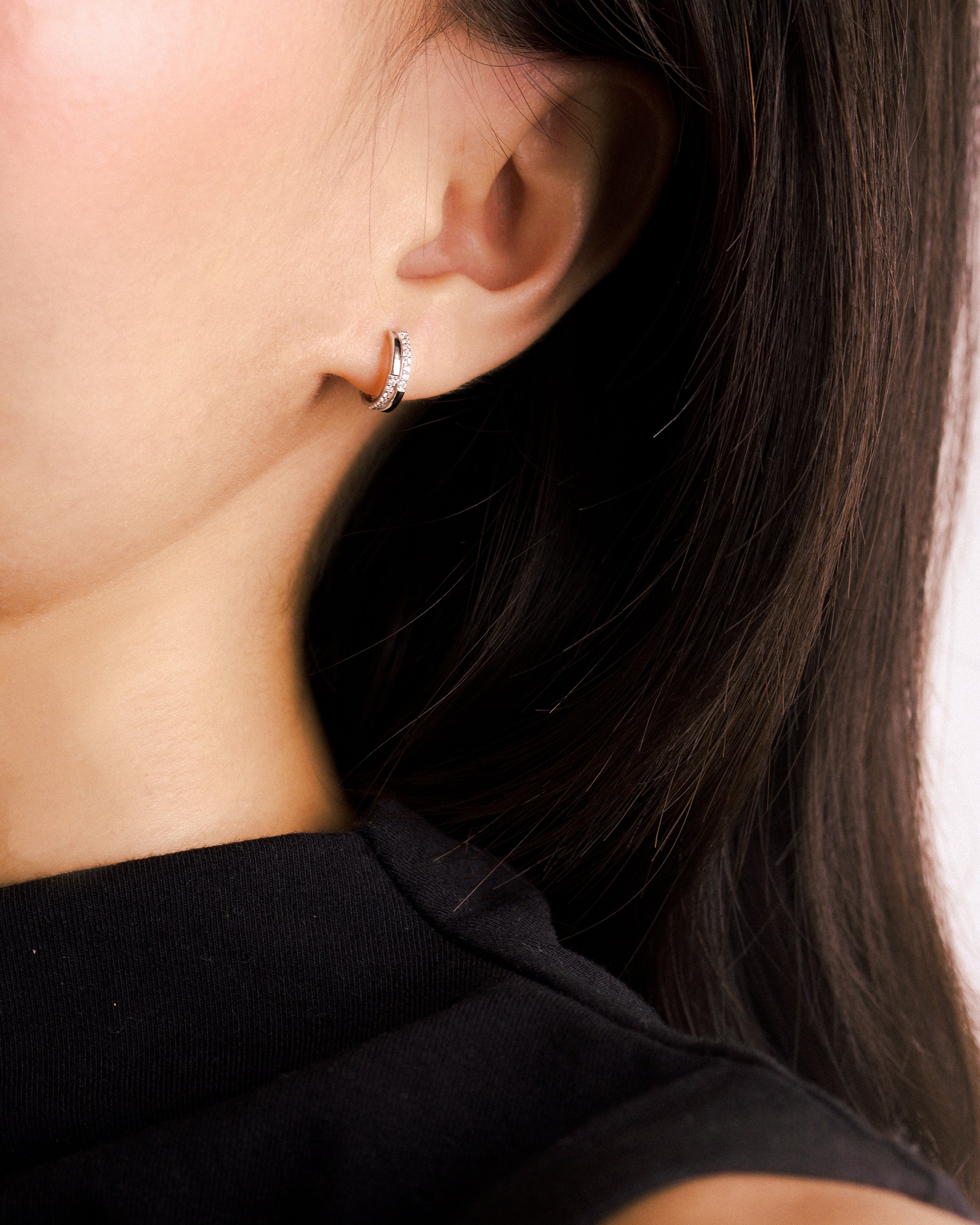 Fine jewellery, silver jewellery, hypoallergenic, tarnish-free, zoomed out front view of a silver hoop earrings embedded with crystals