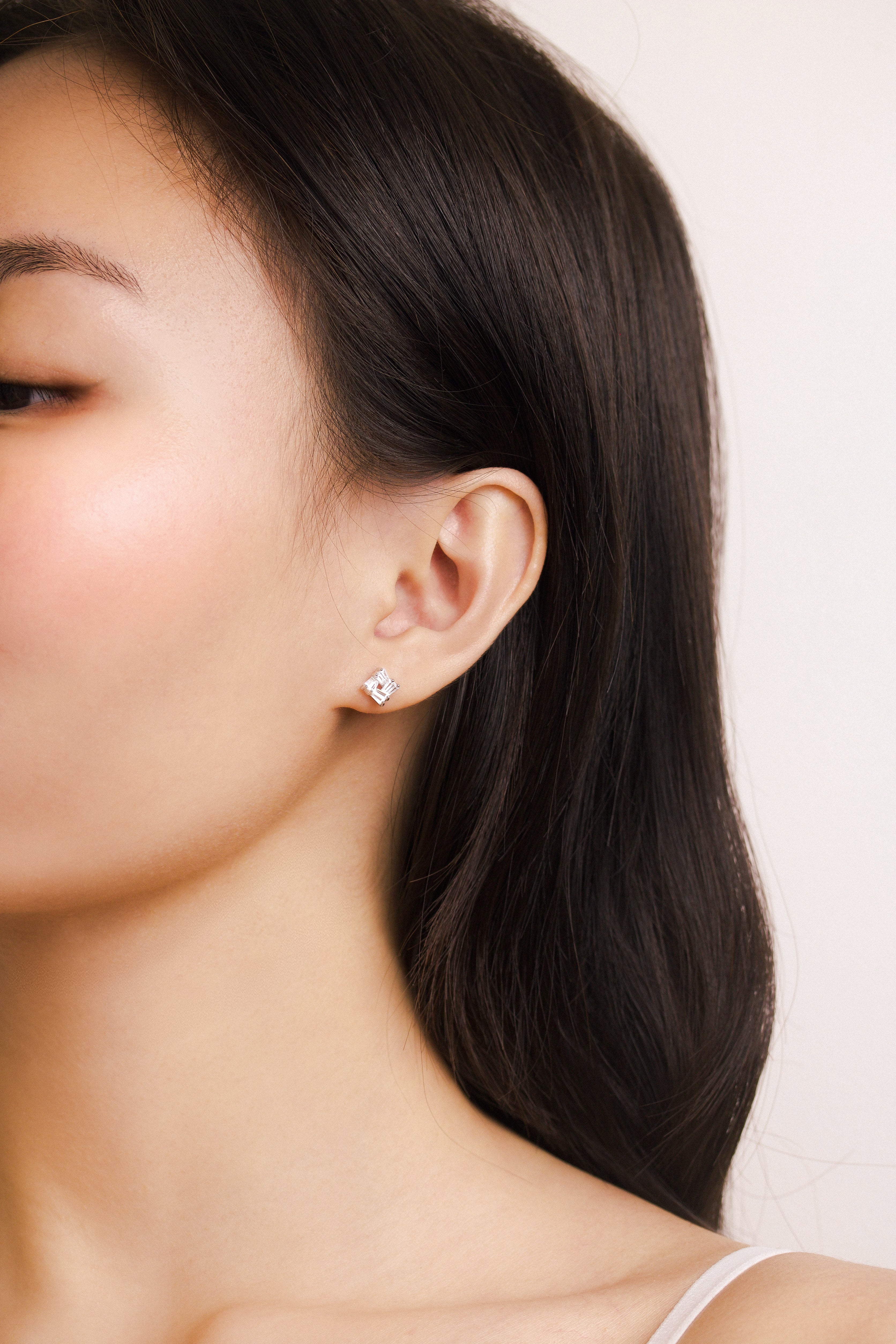 Fine jewellery, silver jewellery, hypoallergenic, tarnish-free,
full side view of a silver square stud crystal earrings worn on a person's ear