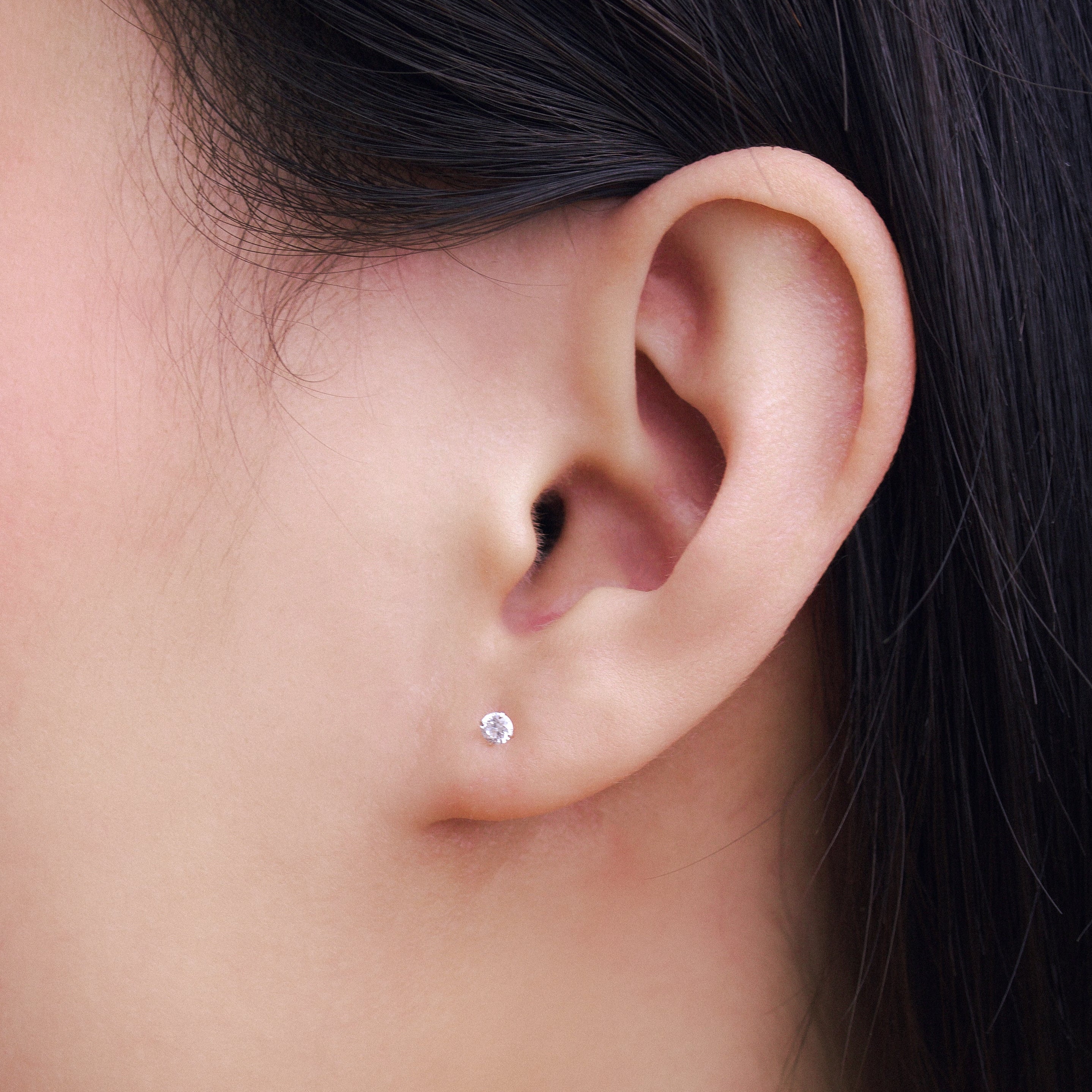 Fine jewellery, silver jewellery, hypoallergenic, tarnish-free, Side view Close-up of an ear with a crystal stud earring