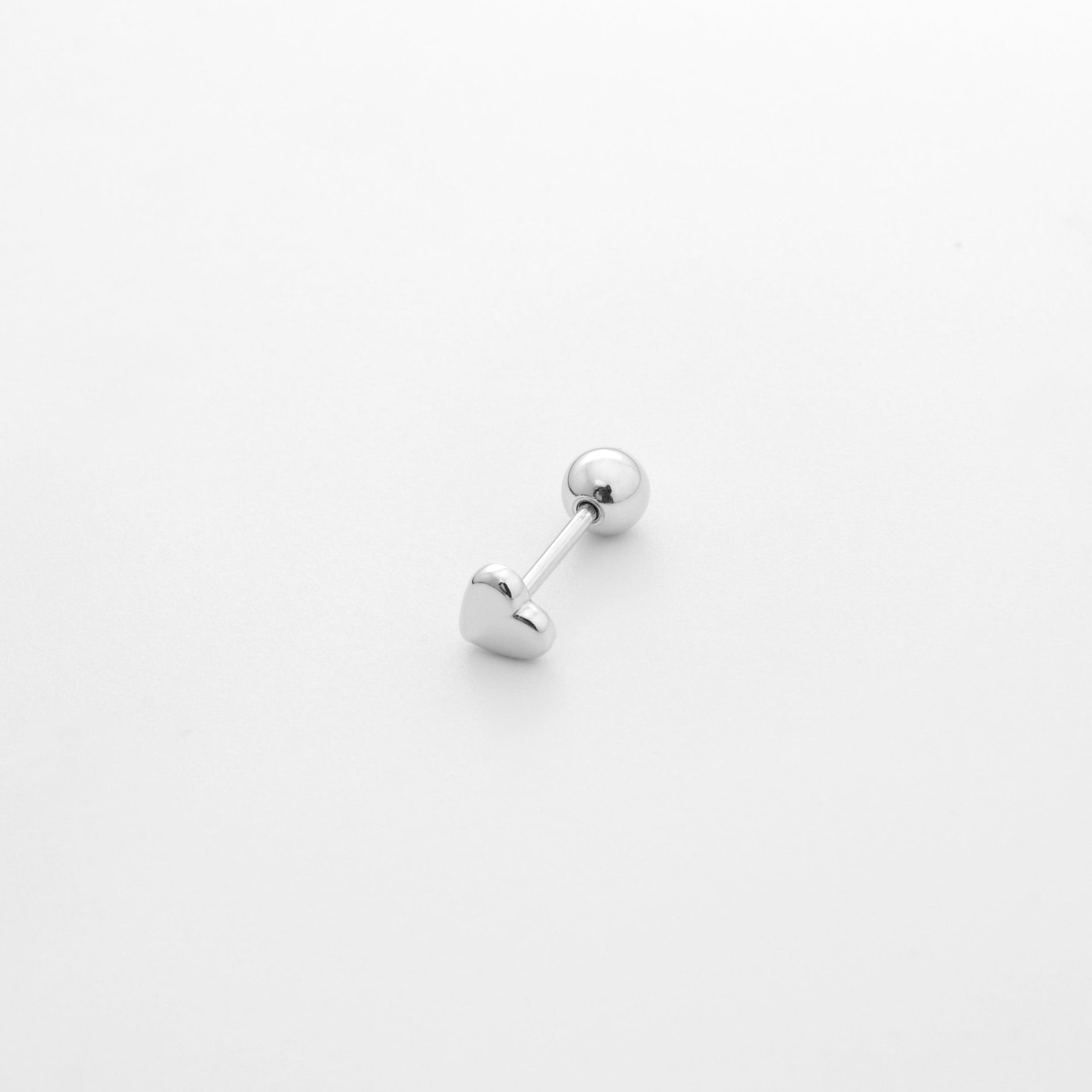Fine jewellery, silver jewellery, hypoallergenic, tarnish-free, Close up overlooking view of a pair of Heart-shaped silver ear studs on a grey background