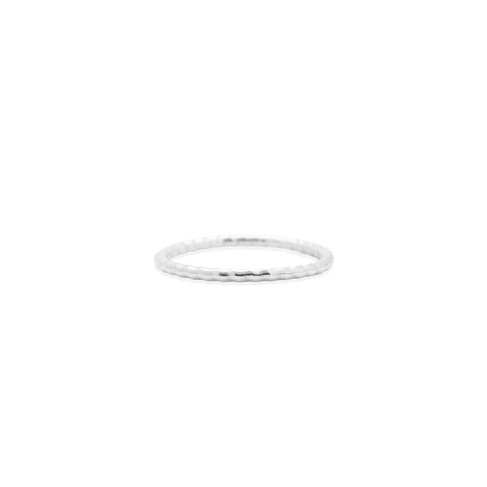 Thin silver ring on a white background, close up front view